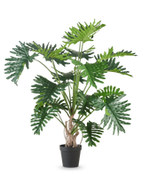 La plante artificielle Philodendron 180 cm possède de grandes feuilles vertes brillantes et profondément lobées et est représentée sur un fond blanc uni.