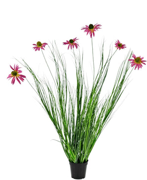 Le Gazon Artificiel Chrysanthème 100 cm ignifuge est une plante en pot dotée de longues feuilles vertes et de longues tiges surmontées de fleurs rose vif ressemblant à des marguerites, sur fond blanc.
