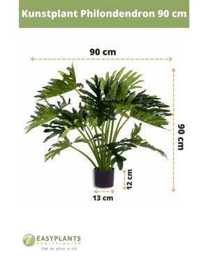 Plante artificielle Philodendron UV 90 cm en pot noir, avec des feuilles de 90 cm de large. Parfait pour n’importe quel espace. Taille du pot : 12 cm de haut, 13 cm de large. Logo Easyplants en bas.