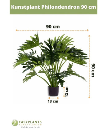 Plante artificielle Philodendron UV 90 cm en pot noir, avec des feuilles de 90 cm de large. Parfait pour n’importe quel espace. Taille du pot : 12 cm de haut, 13 cm de large. Logo Easyplants en bas.