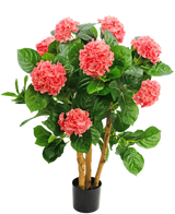 L'hortensia artificiel UV 85 cm rose a plusieurs tiges, de larges feuilles vertes et des fleurs d'hortensia roses dans un pot noir, ce qui offre un contraste vivant et une apparence réaliste.