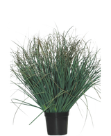 De Kunst Grasplant Gazon groen 50 cm brandvertragend is een groene plant in pot met lange, dunne bladeren en enkele droge bruine punten, die een natuurlijke uitstraling geeft aan elke ruimte tegen een effen witte achtergrond.